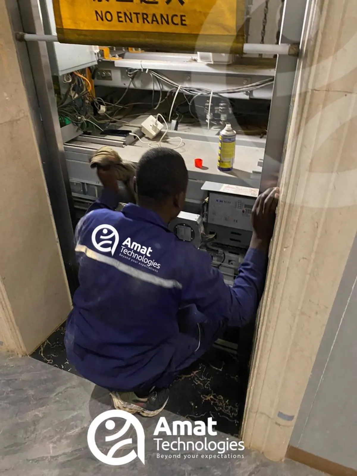 AMAT technician overhauling elevator shaft mechanical gear