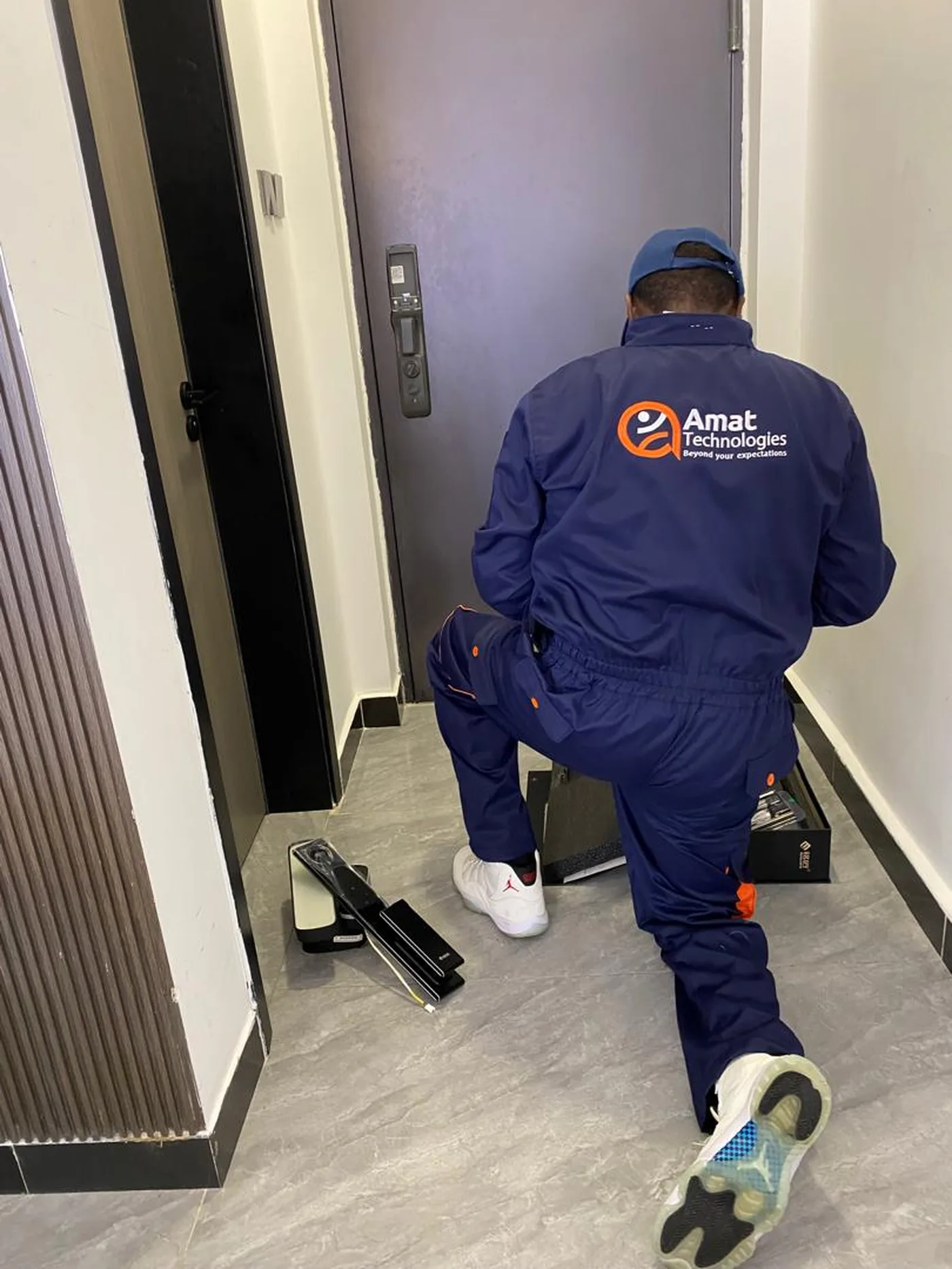 AMAT technician fitting a biometric smart door lock on site