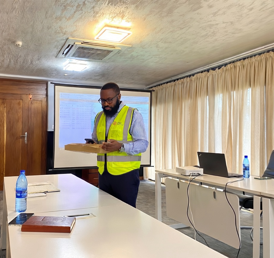 AMAT field technicians reviewing plans beside industrial fuel tanks